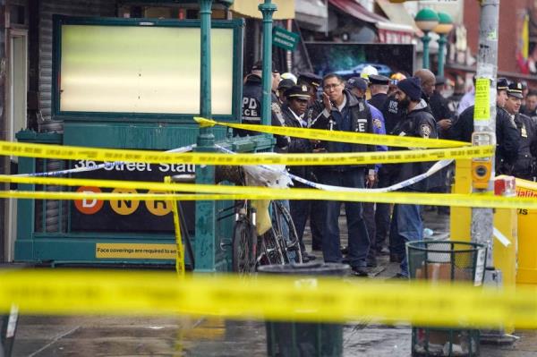 police tape and police officers outside the subway station