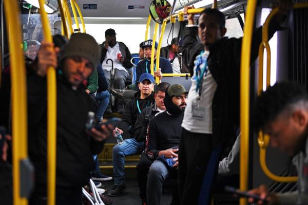 Venezuelan migrants depart from the Randall's Island tent city shelter to board a Manhattan bound city bus to search for city provided benefits and clothing on Nov. 1.