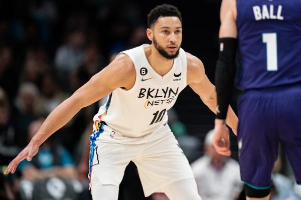 Ben Simmons #10 of the Brooklyn Nets guards LaMelo Ball #1 of the Charlotte Hornets in the second quarter during their game at Spectrum Center on December 31, 2022 in Charlotte, North Carolina.