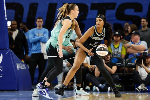 Angel Reese controls the ball against the New York Liberty during the first half of a WNBA game at Wintrust Arena.