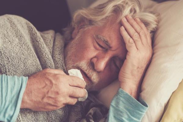 senior man with winter seaso<em></em>nal illness fever cold problems