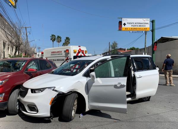 A member of the Mexican security forces stands next to a white minivan with North Carolina plates and several bullet holes, at the crime scene wher<em></em>e gunmen kidnapped four U.S. citizens who crossed into Mexico from Texas, Friday.