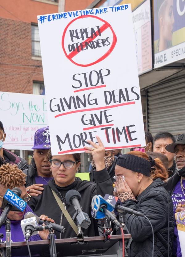 Dominique Luzuriaga wife of NYPD Detective Jason Rivera speaks to a crowd of Around 50-75 victims of violence gather outside Assemblyman Carl Heastieas Bronx office 