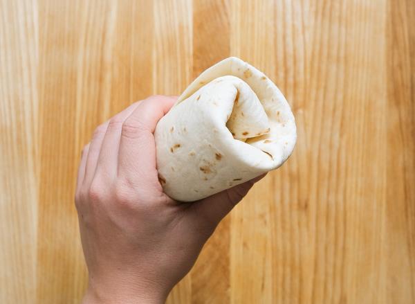 holding a folded burrito