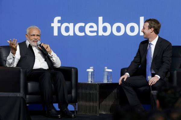 Prime Minister of India Narendra Modi, left, speaks next to Facebook CEO Mark Zuckerberg at Facebook in Menlo Park, Calif., Sunday, Sept. 27, 2015. A rare visit by Indian Prime Minister Narendra Modi this weekend has captivated his extensive fan club in the area and commanded the attention of major U.S. technology companies eager to extend their reach into a promising overseas market. (AP Photo/Jeff Chiu)