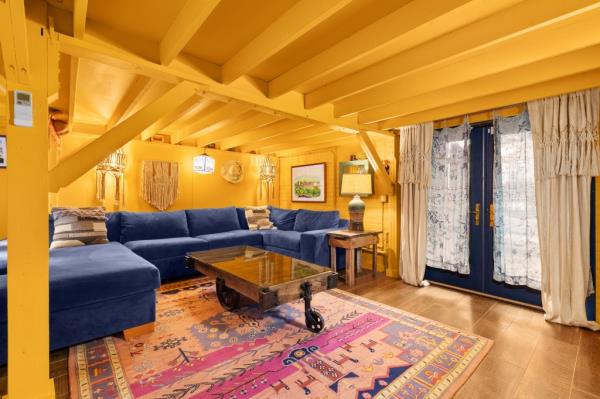 A yellow-painted seating area with beamed ceilings.