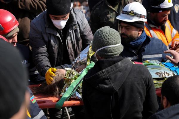 A rescuer strokes Aisha's head.