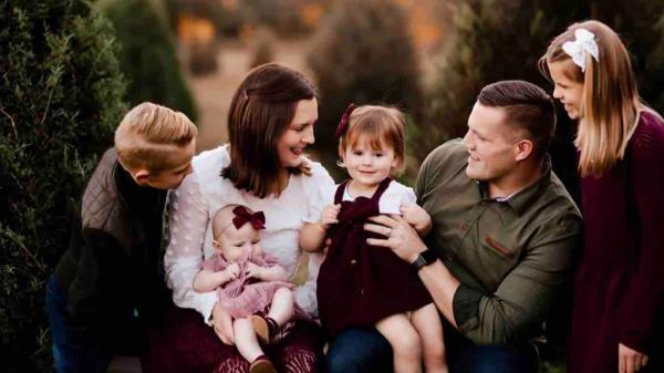 Jared Bridegan poses with his wife, Kirsten, and their children.