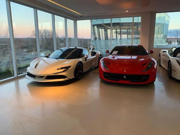 One white and one red Ferrari seen inside the Ferrari of Long Island dealership.