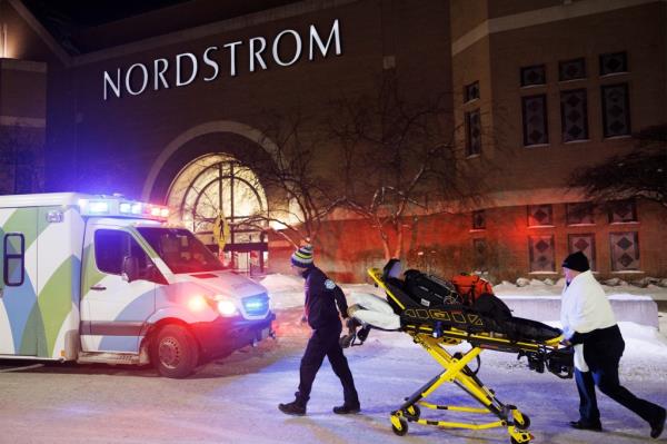 Two first respo<em></em>nders and an ambulance are seen at the entrance to Nordstrom at the Mall of America in Bloomington, Minn., after reports of shots fired on Friday, Dec. 23, 2022. 