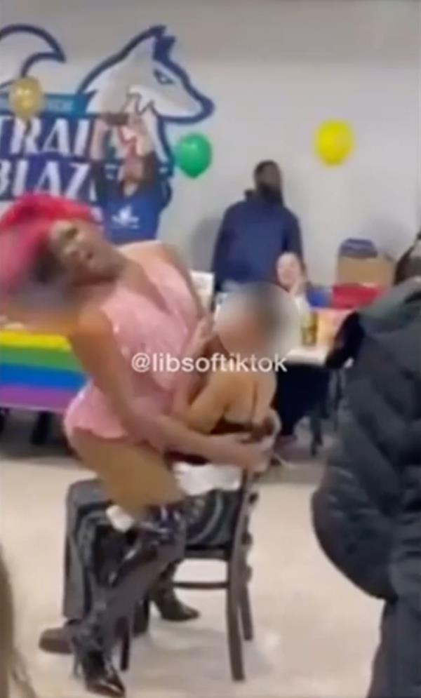 A new viral video shows a drag queen straddling a young girl during an LGBTQ pride event at a North Carolina school that enrolls students as young as 14.