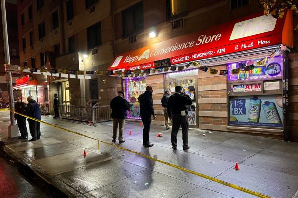 Police survey the scene of the shooting.