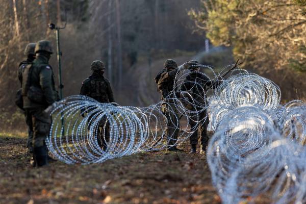 Soldiers of the Polish army install co<em></em>ncertina wire at Poland's border with Russian exclave Kaliningrad on November 14, 2022 in Goldap, Poland. 