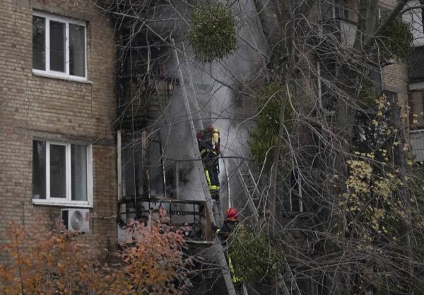 Ukrainian State Emergency Service firefighters work to extinguish a fire at the scene of a Russian shelling in Kyiv, Ukraine, Tuesday, Nov. 15, 2022. 