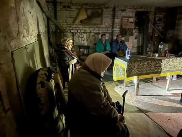 People hiding in a bomb shelter in Shebekino during the shelling.