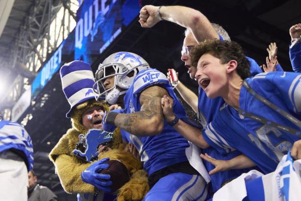 Detroit Lions wide receiver Josh Reynolds celebrates a touchdown with fans during an NFL divisio<em></em>nal round playoff game against Tampa Bay on Jan. 21, 2024, in Detroit. 