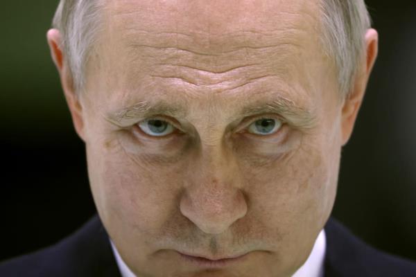 A photo including Russian President Vladimir Putin