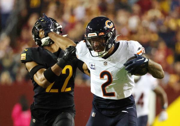 Bears receiver DJ Moore stiff-arms Commanders safety Darrick Forrest as he runs for extra yards after catching a pass against the Commanders  on Oct. 5 at FedEx Field in Landover, Md.