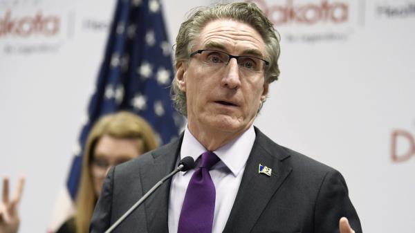 North Dakota Gov. Doug Burgum gestures as he speaks