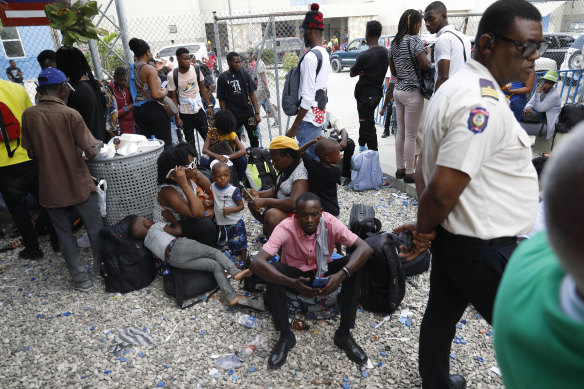 Haitians waiting to board a flight to Nicaragua gather after the government banned all charter flights to Nicaragua, at Toussaint Louverture Internatio<em></em>nal Airport in Port-au-Prince, Haiti.