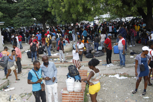 Haitians waiting to board a flight to Nicaragua gather after the government banned all charter flights in Port-au-Prince, Haiti. 