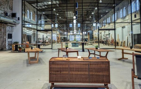 The showroom of Sandtown Furniture's new location is separated from the manufacturing area by a thick glass wall.