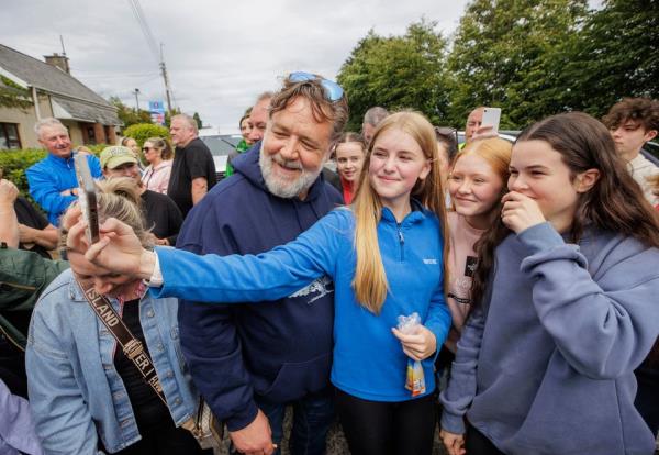 Actor Russell Crowe poses for selfies with locals outside the new craft distillery in Muff, Co Donegal. Photo: PA