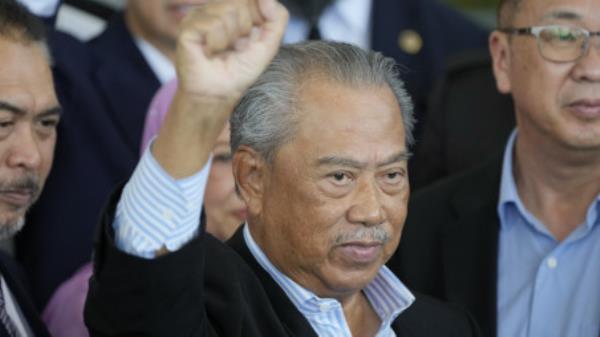 Malaysia's former Prime Minister Muhyiddin Yassin poses for media outside courthouse, after charged with corruption and mo<em></em>ney laundering, in Kuala Lumpur, Malaysia, Friday, March 10, 2023. Muhyiddin has been charged with corruption and mo<em></em>ney laundering, making him Malaysia's second ex-leader to be indicted after leaving office. Muhyiddin pleaded innocent Friday to four charges of corruption and two charges of mo<em></em>ney laundering. (AP Photo/Vincent Thian)