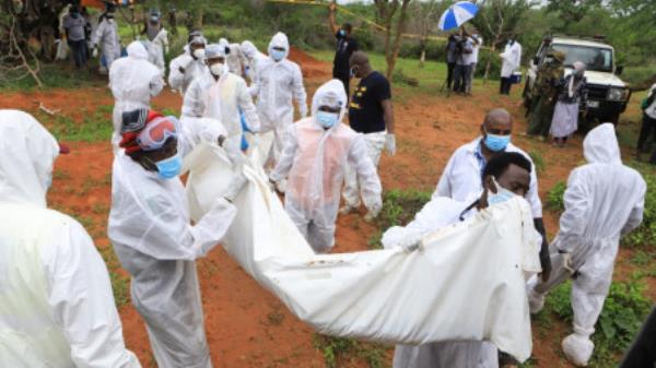 Forensic experts and homicide detectives carry the bodies of suspected members of a Christian cult named as Good News Internatio<em></em>nal Church, who believed they would go to heaven if they starved themselves to death, after their remains were exhumed from their graves in Shakahola forest of Kilifi county, Kenya 22 April, 2023. REUTERS/Stringer