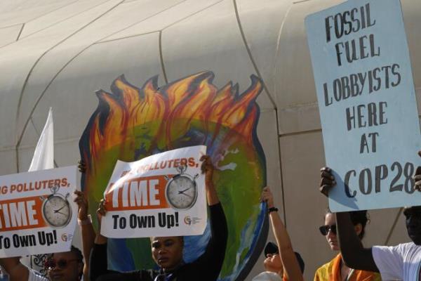 People participate in a demo<em></em>nstration against fossil fuels at the COP28 UN Climate Summit, December 5, 2023, in Dubai, United Arab Emirates. 