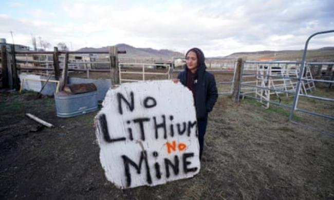 Daranda Hinkey holds a large hand-painted sign that says ‘No lithium, no mine’.