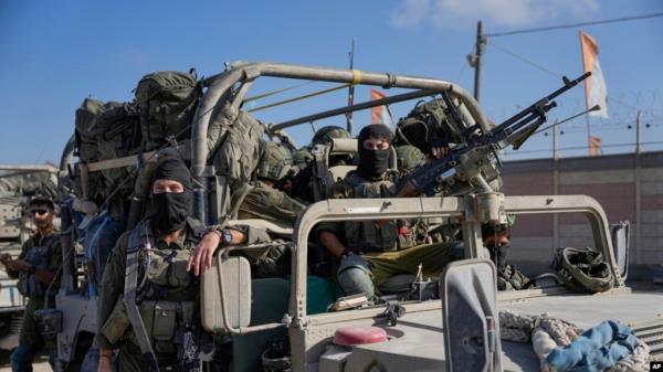 Israeli army troops are seen on the Israeli-Gaza border during a ground operation in the Gaza Strip, Nov. 8, 2023. 