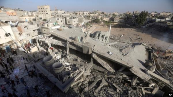 Palestinians inspect the damage of a destroyed mosque following an Israeli airstrike in Khan Younis refugee camp, southern Gaza Strip, Nov. 8, 2023.