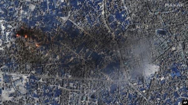 This image provided by Maxar Technologies shows a shortwave Infrared view of burning buildings and active fires in Gaza City, Nov. 7, 2023. In SWIR satellite imagery, fires and thermal hot spots show up as an orange/yellow bloom.