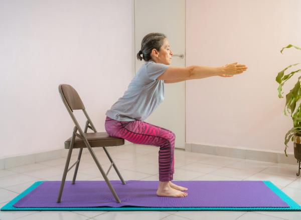 chair yoga exercise, co<em></em>ncept of daily chair yoga workout to shrink belly fat