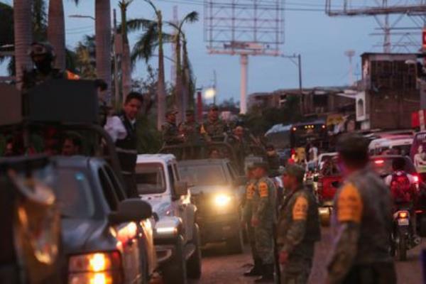 Members of the security forces in co<em></em>nvoy on a highway near the entrance to Acapulco after Hurricane Otis made landfall. 