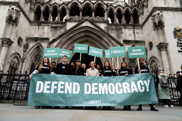 Liberty members holding a banner outside the Royal Courts of Justice