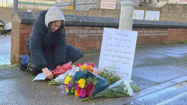 Flowers are left at the entrance at Portland Port in Dorset, following the death of an asylum seeker on board the Bibby Stockholm accommodation barge. Police were called to reports of a 