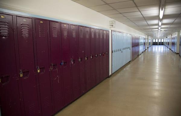 An empty school hallway with lockers.