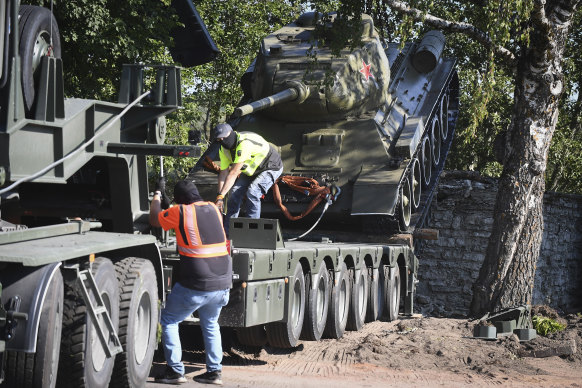 Workers removing a Soviet T-34 tank installed as a mo<em></em>nument in Narva, Estonia, in August 2022.