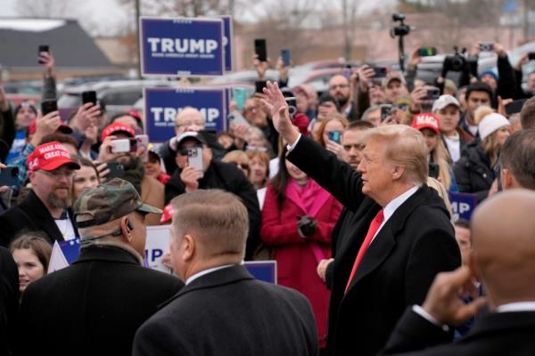 Republican presidential candidate former President Do<em></em>nald Trump waves to supporters as he arrives at a campaign stop in Londonderry, N.H., Tuesday, Jan. 23, 2024. 