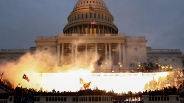 An explosion caused by a police munition is seen while supporters of U.S. President Do<em></em>nald Trump riot in front of the U.S. Capitol Building in Washington, U.S., January 6, 2021. REUTERS/Leah Millis/File Photo