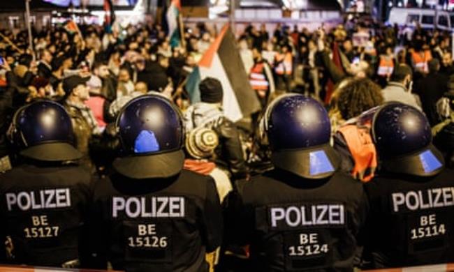 Police in Berlin stand guard during a pro-Palestine march.