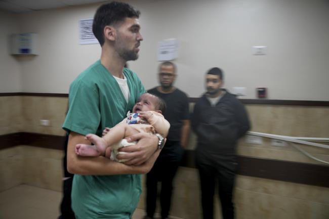 A Palestinian baby wounded in the Israeli bombardment of the Gaza Strip is brought to a hospital in Deir al-Balah on Tuesday, Nov. 14, 2023. (AP)