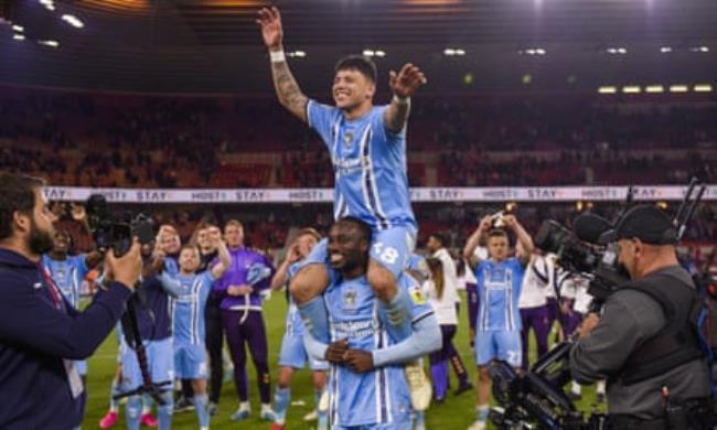 Fankaty Dabo, of Coventry City, lifts Gustavo Hamer on his shoulders after beating Middlesbrough