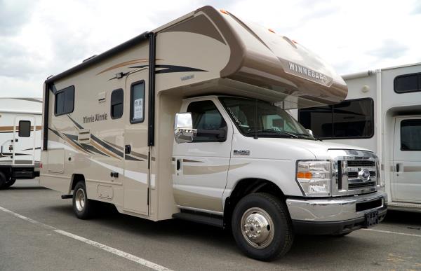 A pair of Winnebago motorhomes are ready for sale at a dealer in Golden