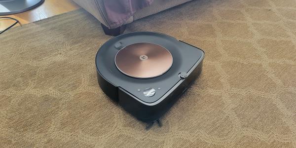 Roomba s9+ on beige area rug