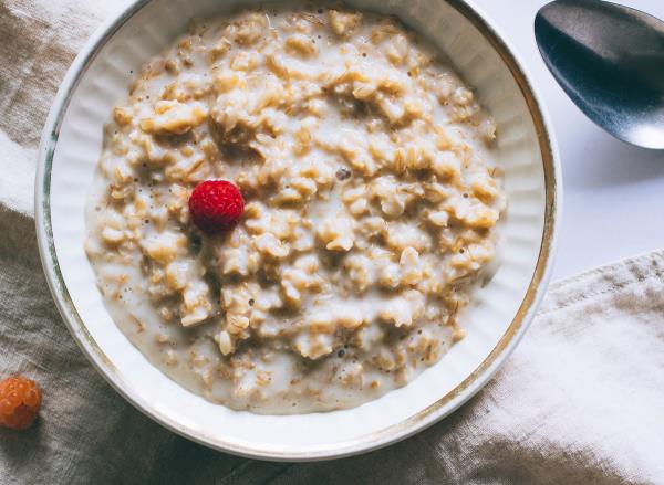 Bowl of plain oatmeal with milk for breakfast