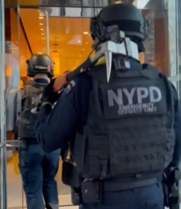 NYPD officers in tactical gear enter the Millennium Hotel to evict Hurricane Ida victims on Saturday, Feb. 25, 2023.