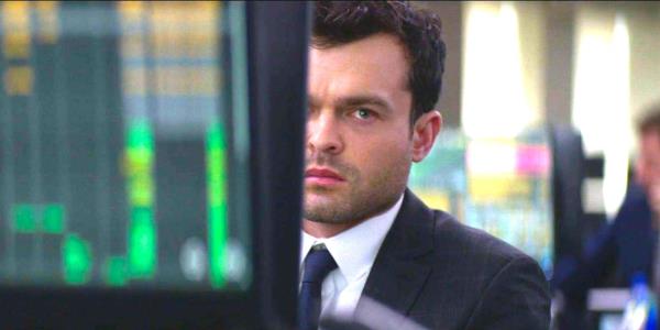 Alden Ehrenreich in Fair Play peering out mysteriously from behind a computer monitor